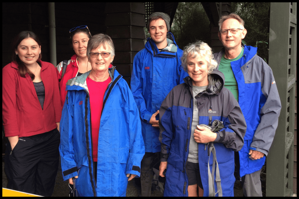 Author and her party of six stand in front of the Fiordland National Park Visitor Centre before starting the Milford Track.