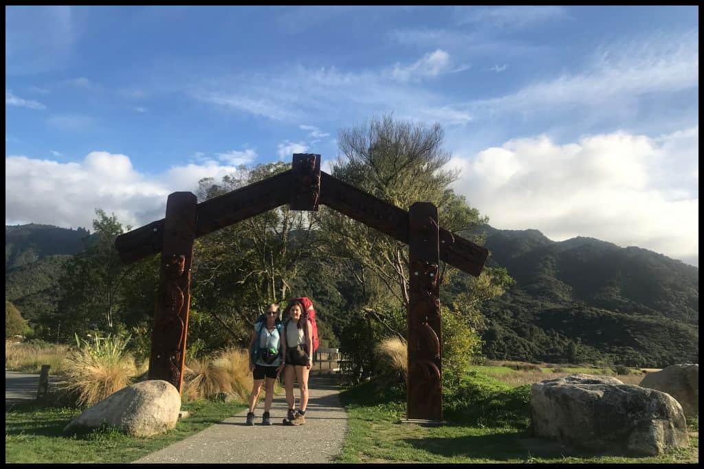Author and her mother stand under the Maori gateway at the Marahau end of the Abel Tasman Coastal Track.