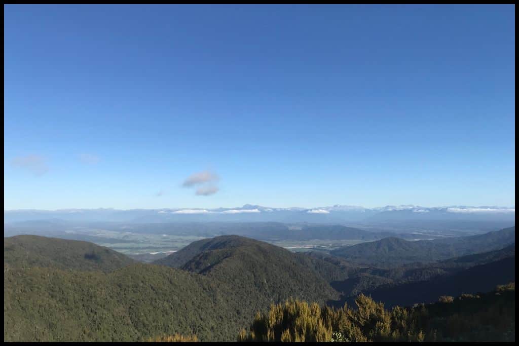 Blue skies over the valley: the view from Ces Clark Hut on the Paparoa Track.