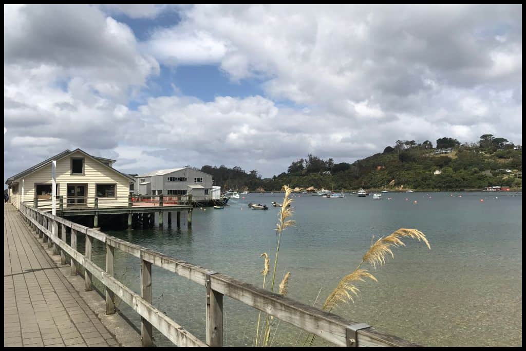 A scenic shot shows the wharf at Stewart Island and the ferry terminal building.