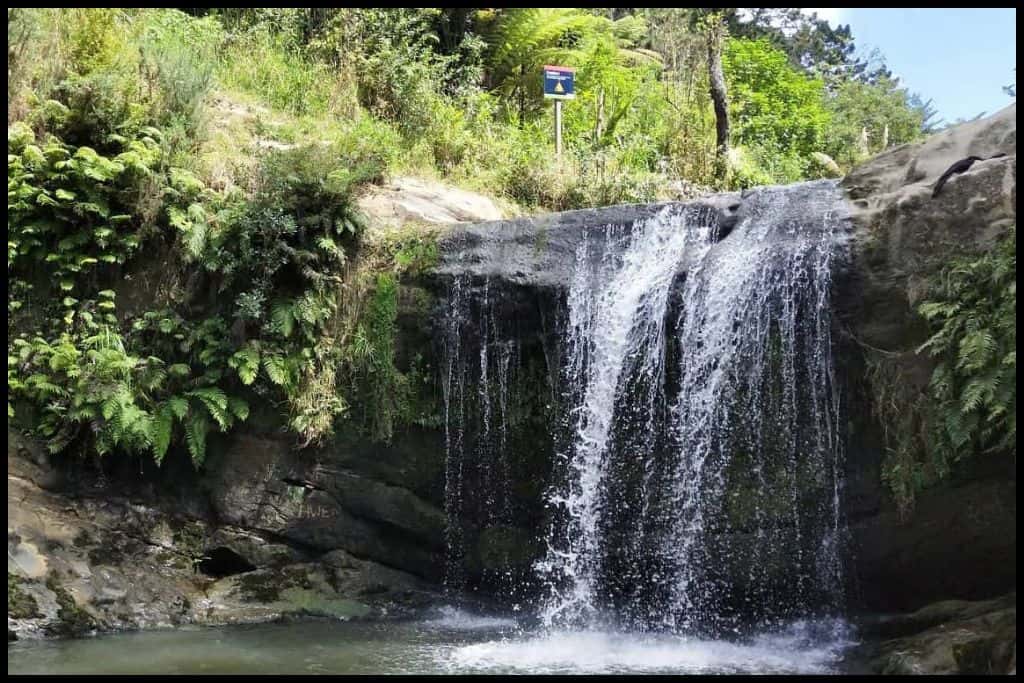 Oakley Creek Waterfall spills over the rocks and into the pool below.