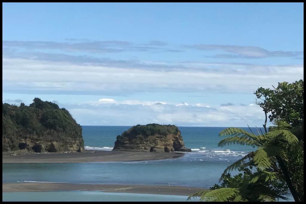 Elephant Rock sits between the black sands of Three Sisters Beach and the ocean. From this angle, the feet and trunk of the elephant are visible.