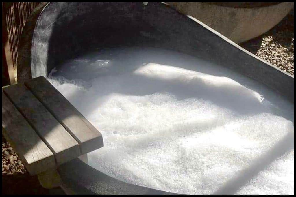 A curved stone bath filled with milk and bubbles: The Castaways Resort and Day Spa at Kariotahi Beach specialises in milk baths.
