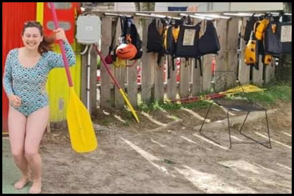 Young female in swimwear poses with her rafting paddle at Kaituna River Rafting.