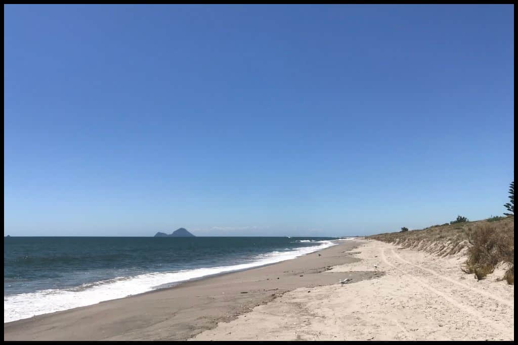 A long expanse of sand and surf at Matatā Beach.