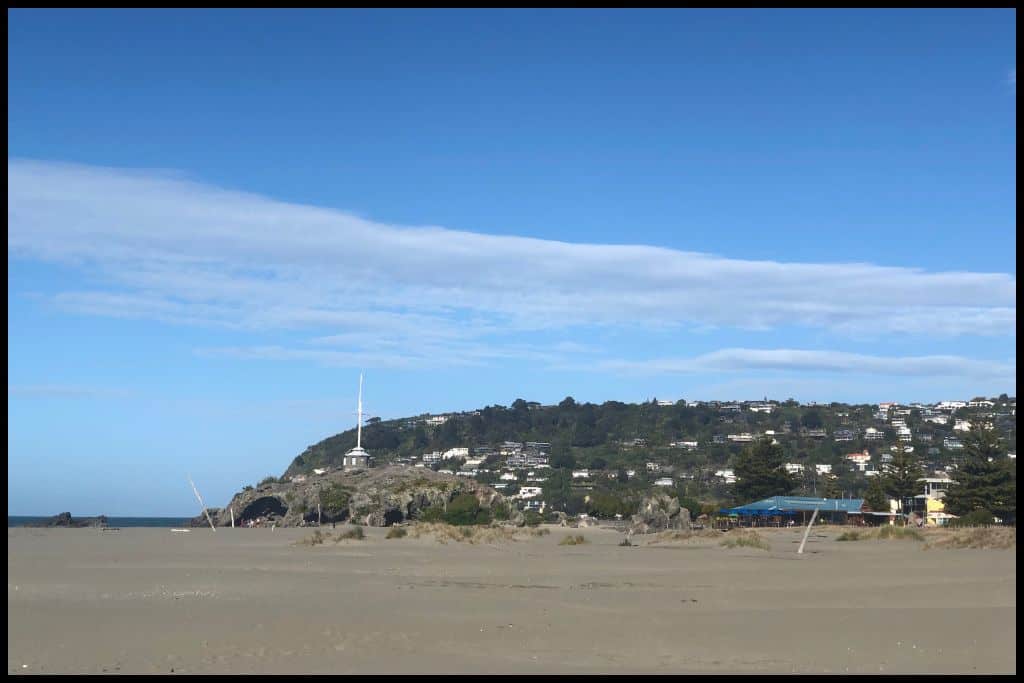 Cave Rock, Sumner Beach, and the hillside suburbs on the headland overlooking it all.