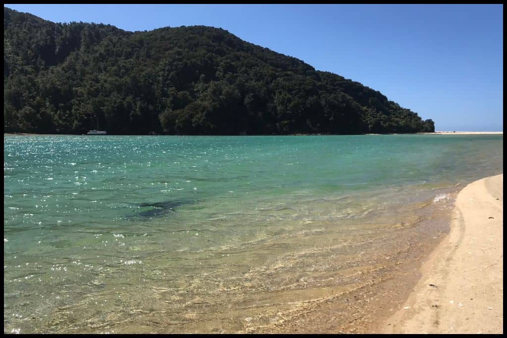 Clear, turquoise water sparkles in the sunlight.