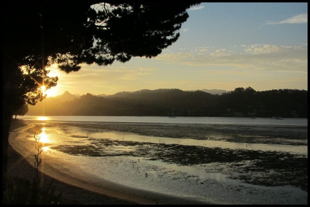 The sun sets over Tairua River Mouth.