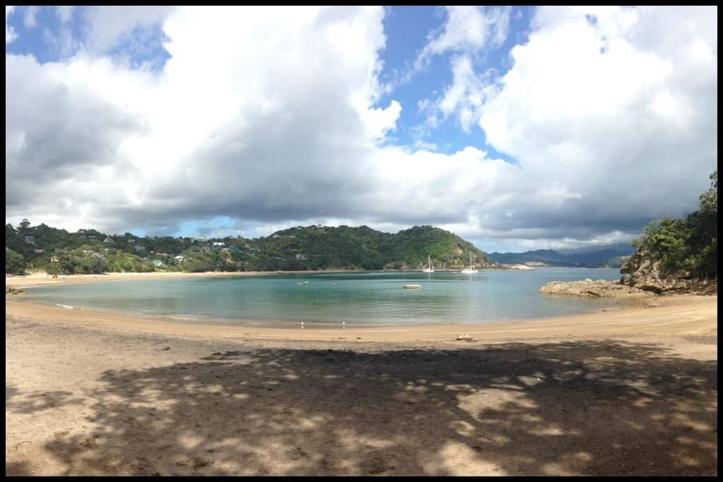 A curved panorama captures the curve of Little Waikawau Bay at low tide.
