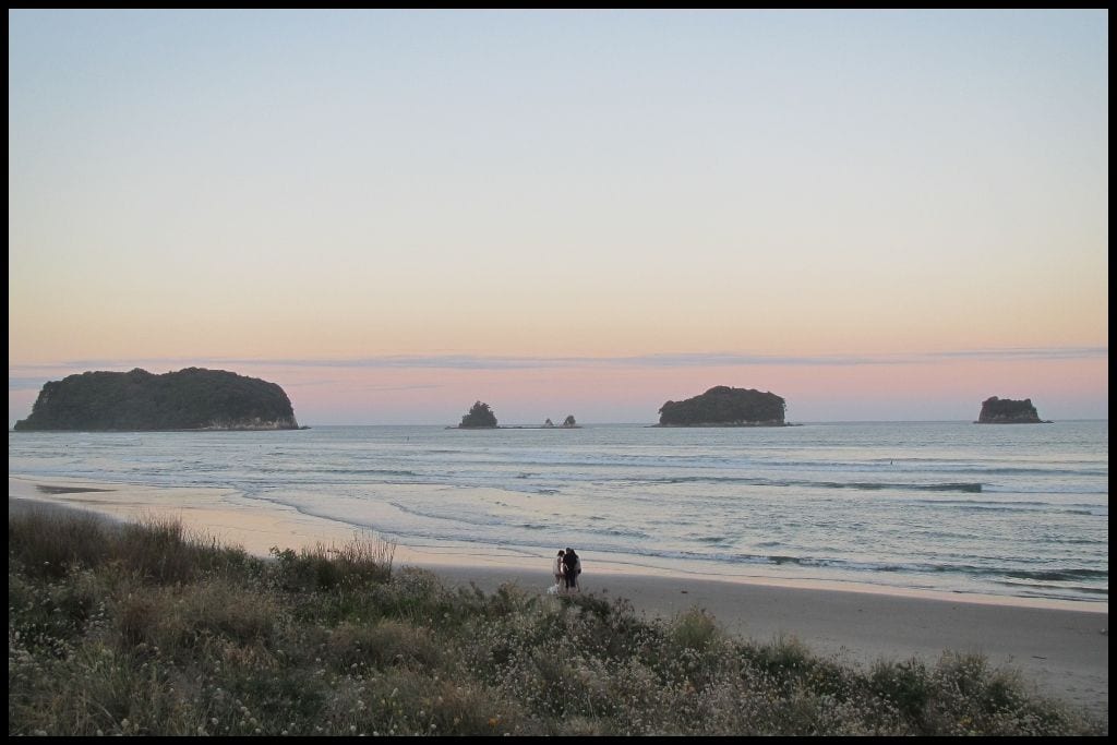 Pastels stretch across the horizon, marking the end to sunset at Whangamata Beach.