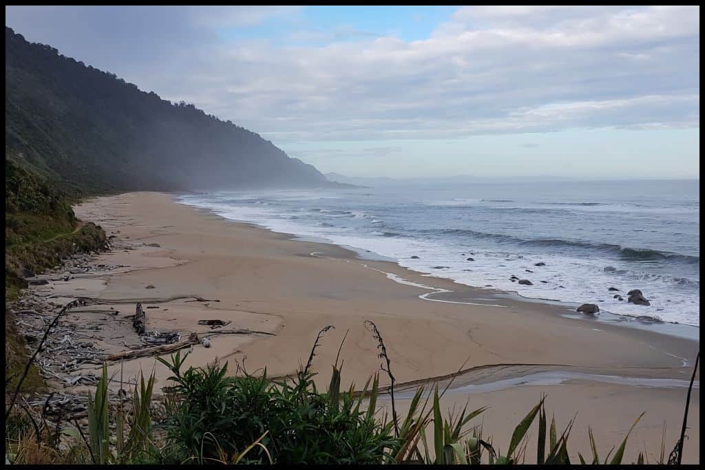 Windswept Scotts Beach, with sea spray making the beach hazy.