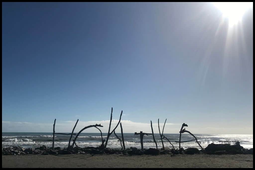 Driftwood letters spell out Hokitika on the Hokitika Beach.